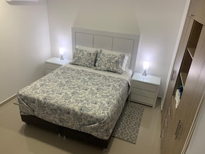 Comfortable queen bed with private bathroom, closet, safe, AC and TV!