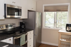 The kitchen features amenities like a dishwasher, air fryer and coffee maker.