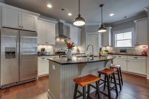 Our kitchens are fully equipped, boasting inviting bar seating for relaxed dining.