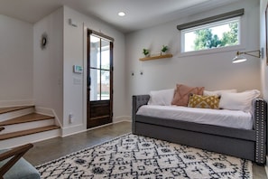 Unwind in our serene first-floor den, where two can rest peacefully on a charming daybed with a pull-out twin trundle.