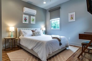 Our sun-drenched, airy room featuring a restful queen bed—a true retreat for relaxation.