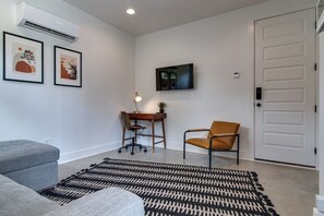 The den sits just off of the garage and transforms into another sleeping area for guests.
