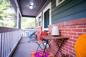 Enjoy your beverage of choice on the screened-in front porch.
