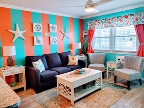 Living room w/ memory foam mattress sleep sofa and room darkening curtains