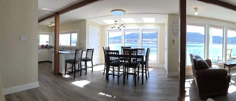 Floor to ceiling windows, kitchen to fireplace in a pano photo