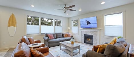 Cozy living room with a gas fireplace and brand new 65 inch Samsung smart TV.