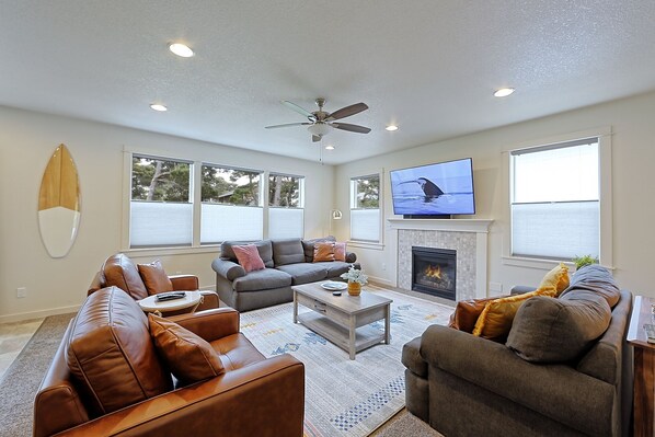 Cozy living room with a gas fireplace and brand new 65 inch Samsung smart TV.