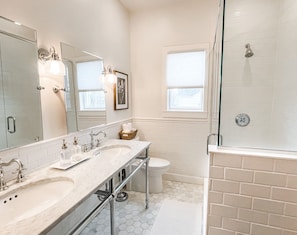Recently remodeled bathroom with double vanities and marble tile & shower. 