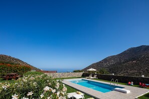 Relax in the Greek sunshine next to the outdoor swimming pool. 
