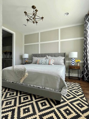 Primary Bedroom features a king size bed, 50" Smart TV, huge walk in closet, and full en suite bathroom