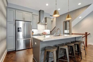 Beautiful open-concept kitchen with plenty of seating at the bar. Home has professional grade appliances, gas range, microwave drawer, and plenty of room to spread out and prepare food or fun Nashville cocktails!