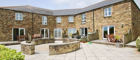 Communal courtyard with sea view.  Each cottage has patio with furniture