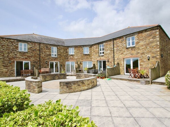 Communal courtyard with sea view.  Each cottage has patio with furniture