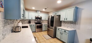 New appliances, large fridge, and plenty of counter and cabinet space.