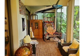 Spacious lanai with sitting area and beach equipment.