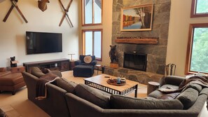 Living room, with 75" Wall mounted TV, Fireplace and seating for everyone. 