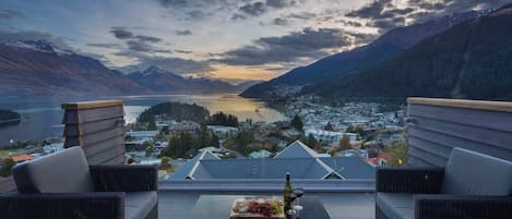 Enjoying happy hour while watching the sunset at luxury accommodation, Queenstown