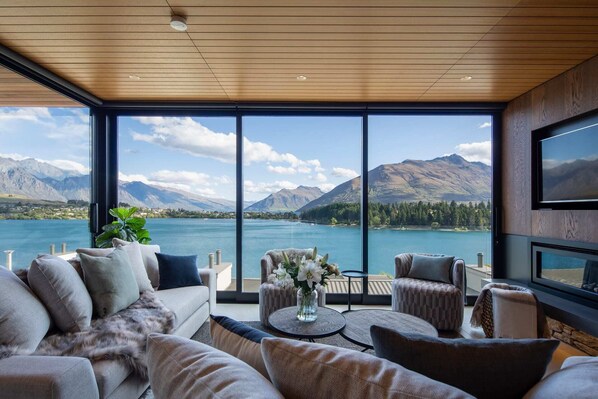 Relax in a beautiful lounge area with breathtaking views of the lake and mountains - New Zealand luxury lodges