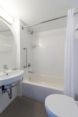 Bathroom with shower and tub. Basic toiletries and towels are provided