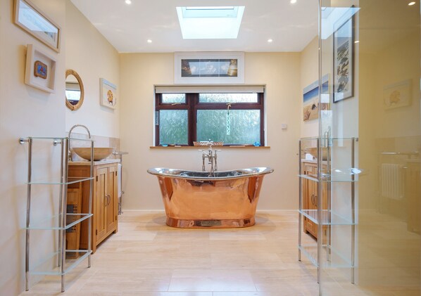 Luxurious family bathroom with stunning William Holland copper bateau bath