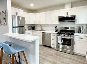 Remodeled Kitchen with quartz counters, and full-sized appliances
