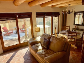 The living room and dining room open to a private patio with a hot tub.