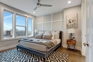 The master suite, located on the third level, features a king bed, smart tv, and full en suite bathroom and incredible views of downtown