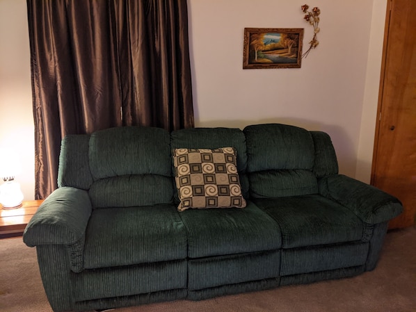 Double reclining couch with a drawer under the middle seat