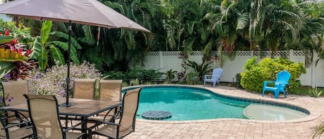 Relax and enjoy the private tropical large back yard area with heated pool