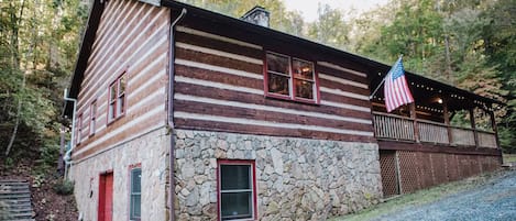 Front porch faces small spring stream and steep hillside, very private