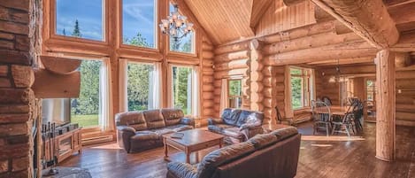 Relax in the cozy living room with soaring ceilings