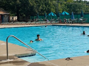 Chill by our pool with comfy loungers, shade, kittie pool, and jacuzzi.