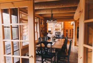 Dining room featuring a wooden table and large windows for natural light