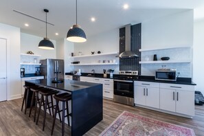 Spacious kitchen equipped with modern appliances and cooking basics to make you favorite meals!