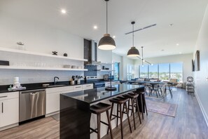 Spacious kitchen equipped with modern appliances and cooking basics to make you favorite meals!