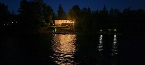 Night view of the home from the lake
