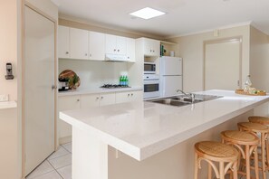 Kitchen with oven,stove, fridge freezer, coffee machine and more