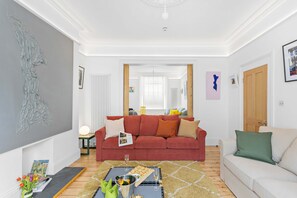 Bright ground-floor living rooms, Victorian pocket-doors create versatile space.