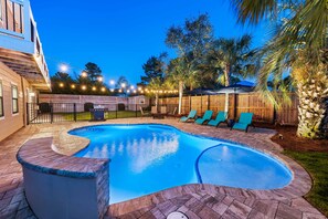 "Nautical Dreams" waterfall pool with heating and cooling available, 4 lounge chairs, large umbrellas and additional seating.