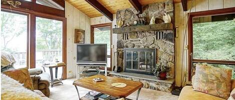 Living Room with Stone Wood Burning Fireplace and Smart TV.  