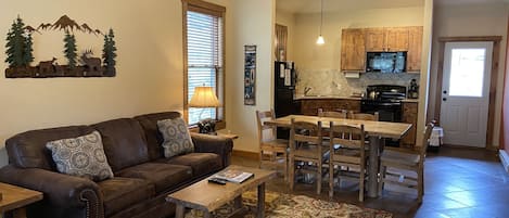 Living room with vaulted ceilings and log accents.