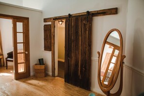 Bathroom entrance, basket w/ workout gear, and full-length mirror