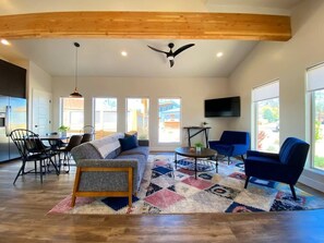 Bask in the sunshine! The open floor plan and expansive windows bathe the living and dining areas in natural light.