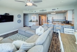 Open living room/kitchen/dining areas looking in from balcony