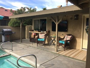 Barbeque table and chairs with pass-through window to kitchen