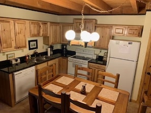 Kitchen with table and seating for 6. 