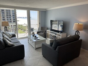 Living room with queen sleeper sofa, 55" TV, loveseat, chair & coastal furniture