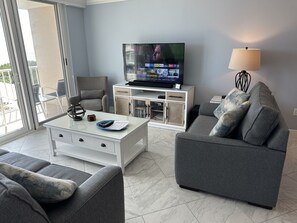 Living room with queen sleeper sofa, 55" TV, loveseat, chair & coastal furniture
