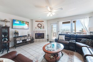 Cozy living space with large windows to allow the natural light to shine in and enjoy the views of the canal