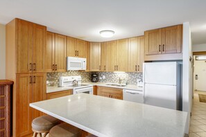 Updated kitchen with modern appliances and custom cabinets.